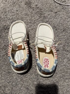 Hey Dude Kids Slip-On Sneakers in White with Red Stripes & Blue Star Heel